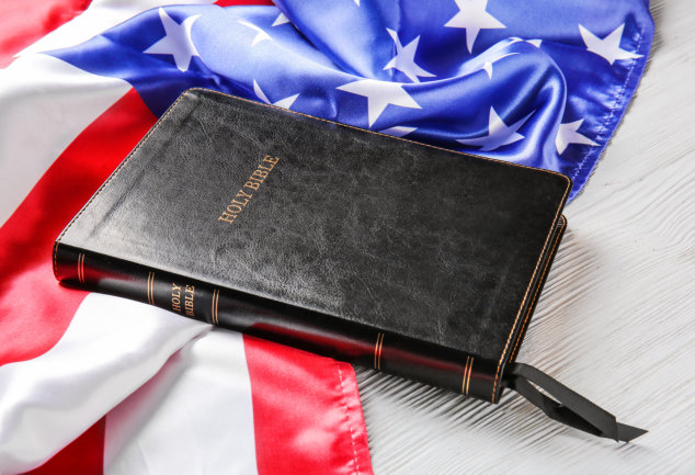 Bible beside American flag